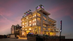 A multi-story hotel with a prominent 'Cynette' sign, multiple balconies, and a well-lit facade. - Cygnett Inn Paras (Dehradun)