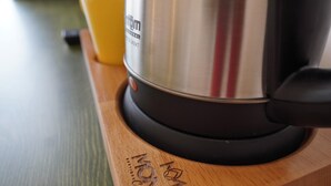 A stainless steel kettle on a wooden coaster with a yellow cup beside it. - Mons Casa Boutique Hotel (Marmaris)