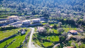 An aerial view of a rural village with terraced fields, stone walls, and scattered houses. - Mons Casa Boutique Hotel (Marmaris)