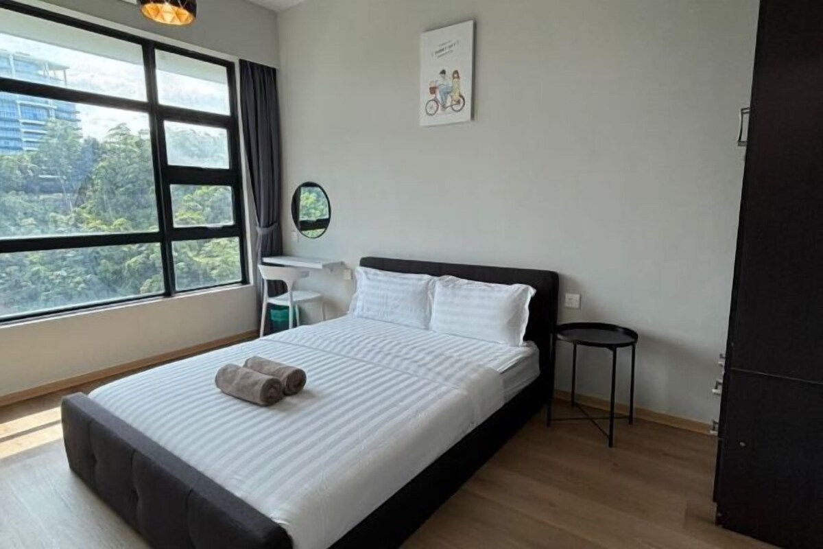 A hotel room with a large window, a bed with white bedding, a small round table, and a wall-mounted mirror.