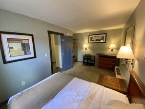 Cozy retreat with a neatly made bed, desk, and dresser, perfect for a comfortable stay.