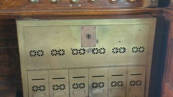 A vintage-style elevator with a wooden panel and brass handles.