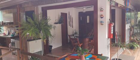 A cozy room with a wooden table, chairs, and potted plants.