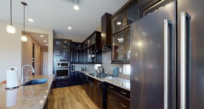 Southwestern stunner with enclosed yard, pool, putting green, & grill