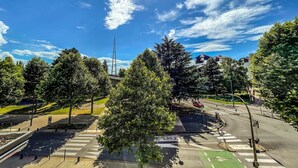 A crosswalk with trees, a tall building, and a clear blue sky. - Annecy 1 bedroom Apt With Balcony (Annecy)