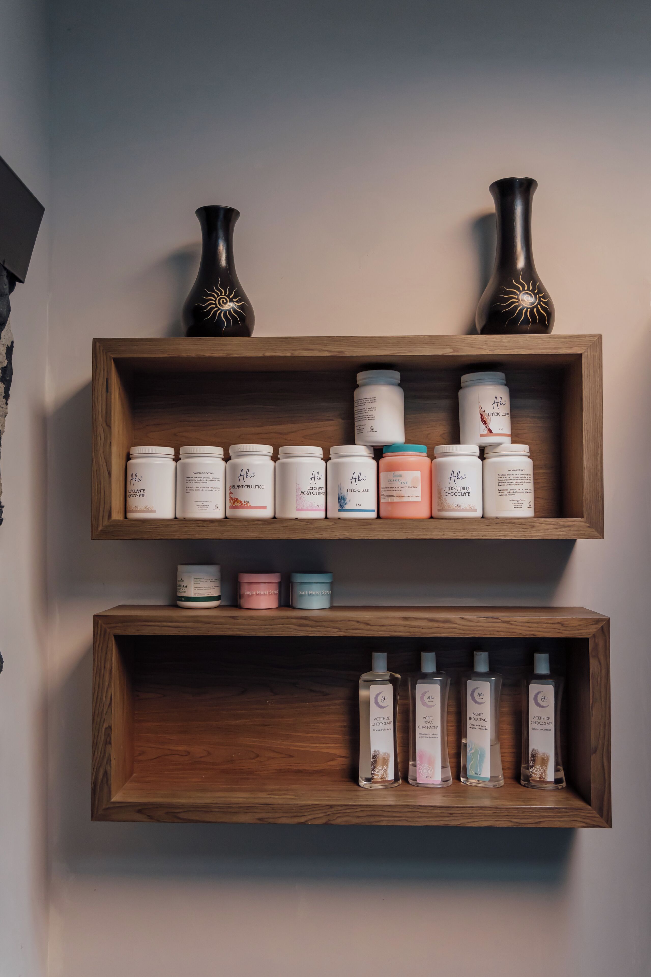 Two wooden shelves with various skincare products.