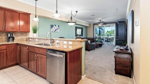 A modern kitchen with granite countertops, stainless steel appliances, and wooden cabinets.