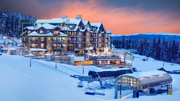 A large, multi-story lodge with a ski lift in the foreground. - Beautiful unit overlooking Mountain ski in ski out luxury property (Breckenridge)