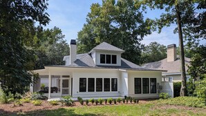 A single-story house with a covered porch, a chimney, and a well-maintained garden. - Charming 4b/3b Newly Constructed Home on Dataw Island - Available 5/15 - 10/15 (Dataw Island)