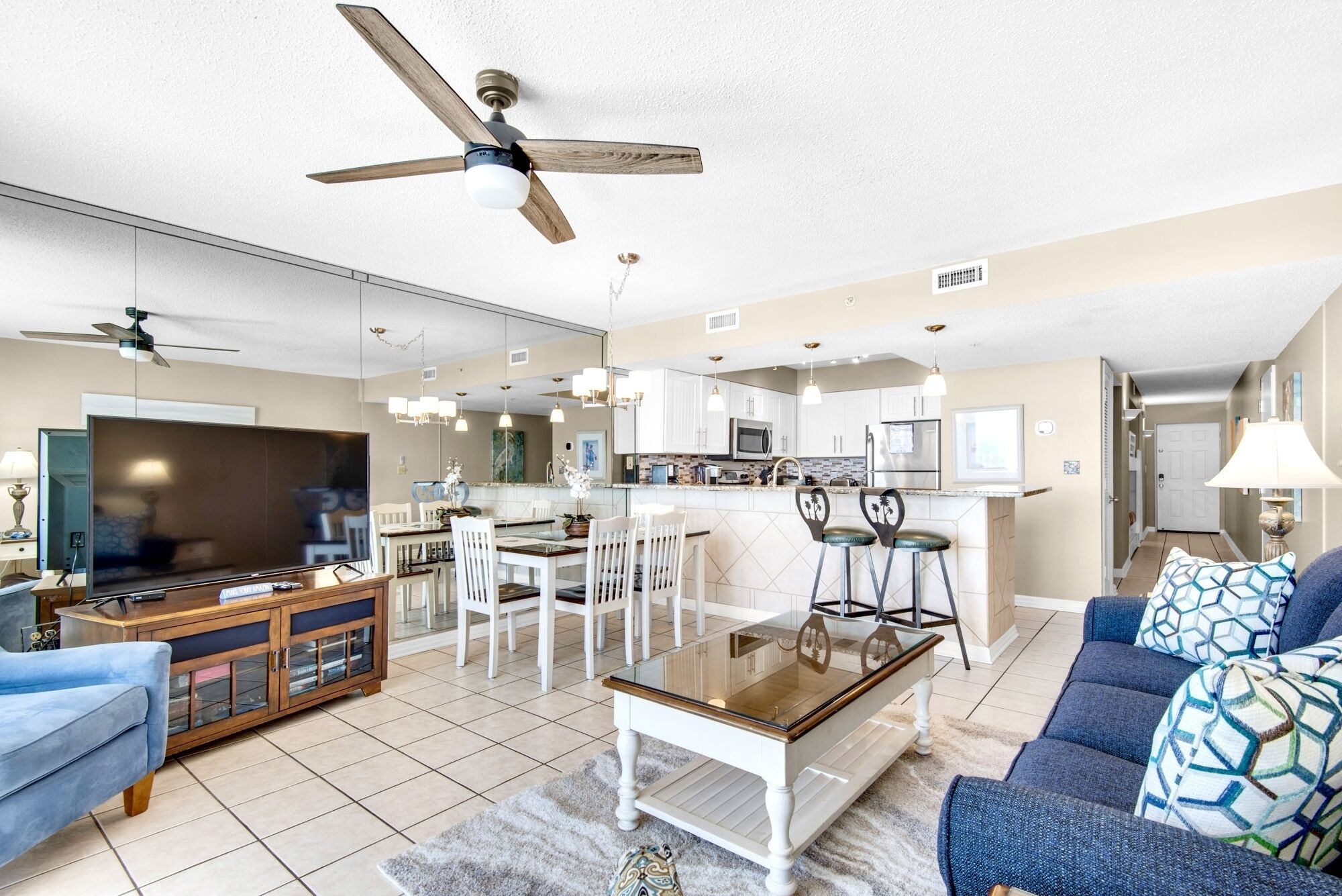 A modern living room with a TV, sofa, and dining area.