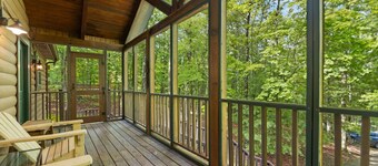 Log Home with fenced in deck & screen porch, cosmopolitan style ranch design.