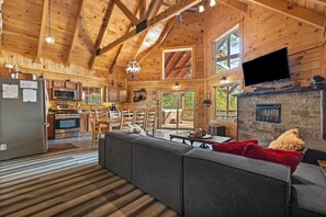 A spacious wooden cabin interior with a kitchen, dining area, and living room. - Phenomenal View! Hot Tub, Pool Table, Bar, Internet, Second Den, Satellite TV (Zoe)