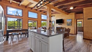 A spacious kitchen with a central island, large windows, and a wooden ceiling. - Nearly 360 degree Mountain View! Private setting, Big Hot Tub, Wi-Fi, Gas Grill (Campton)