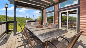 A wooden deck with a table and chairs, a grill, and a scenic view of a forested hill. - Nearly 360 degree Mountain View! Private setting, Big Hot Tub, Wi-Fi, Gas Grill (Campton)