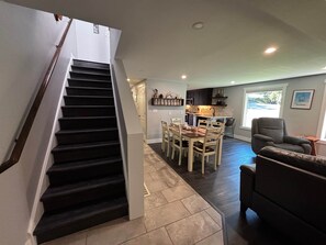 A staircase leading to a dining area with a kitchen in the background. - #3 Ellicottville HIKE, BIKE, GOLF SKI Sleeps 10 / 2.5 Bath (Ellicottville)