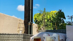 A poolside setting with a showerhead, lounge chairs, and a table with drinks and snacks. - Mitre "The indulgent Experience" (Mendoza)