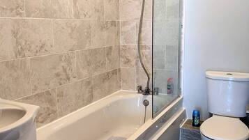 Combined shower/bathtub, hair dryer, towels, soap