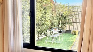 A room with a large window, a white table, and a white rug. - Ñireco House, discover Bariloche from Here. (San Carlos de Bariloche)