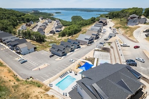 Residents enjoy a tranquil community with a swimming pool, green spaces, and tree-lined streets.
