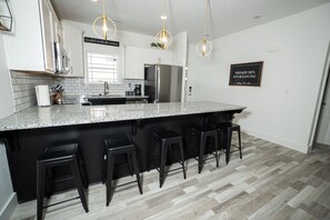 Enjoy cooking in this well-lit kitchen with a large island and stainless steel appliances.