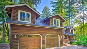 A two-story wooden house with a covered porch and a garage. - The River House' w/ Deck, on McKenzie River! (Springfield)
