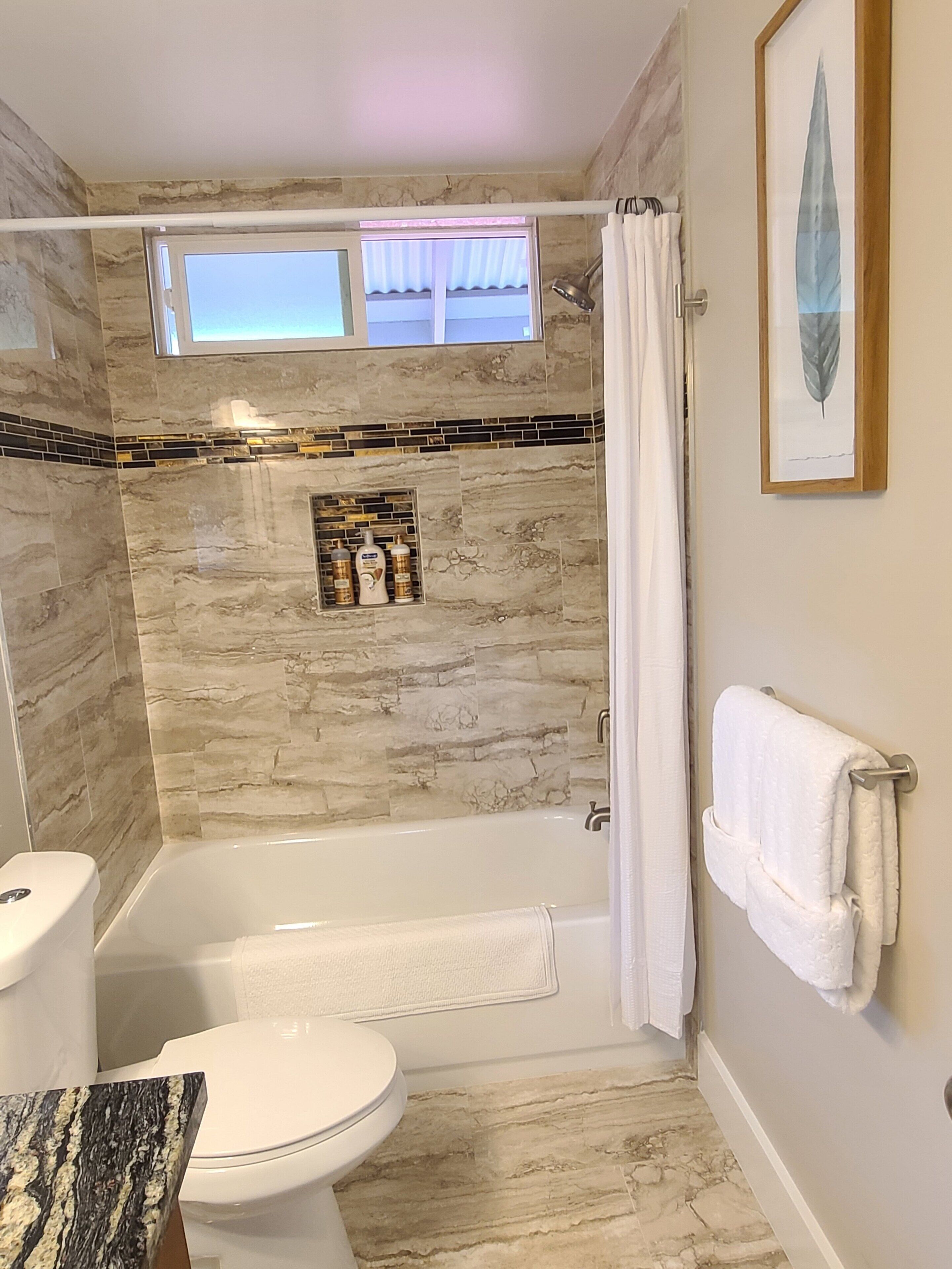 Combined shower/tub, hair dryer, towels, soap