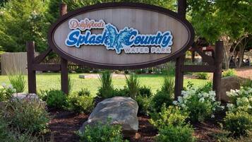A wooden sign for Splash County Water Park with a logo and text.