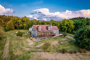 Escape to a serene retreat surrounded by a lush forest and a well-manicured lawn.