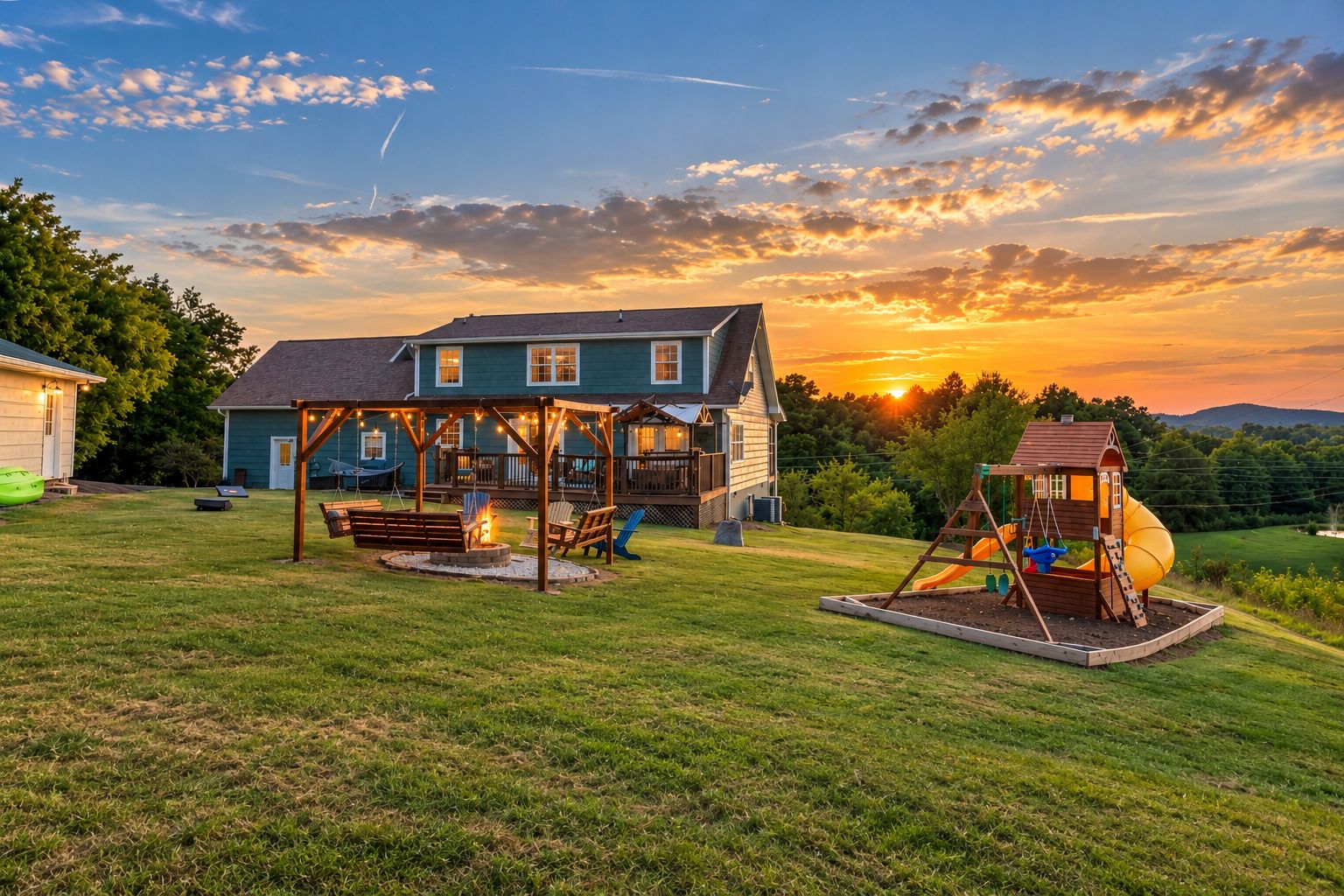 A house with a deck, a swing set, and a playhouse.