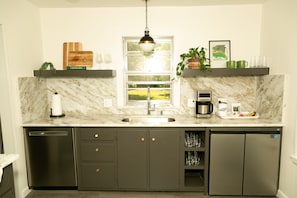 Enjoy cooking in this well-equipped kitchen with a large window offering a view of the outdoors.
