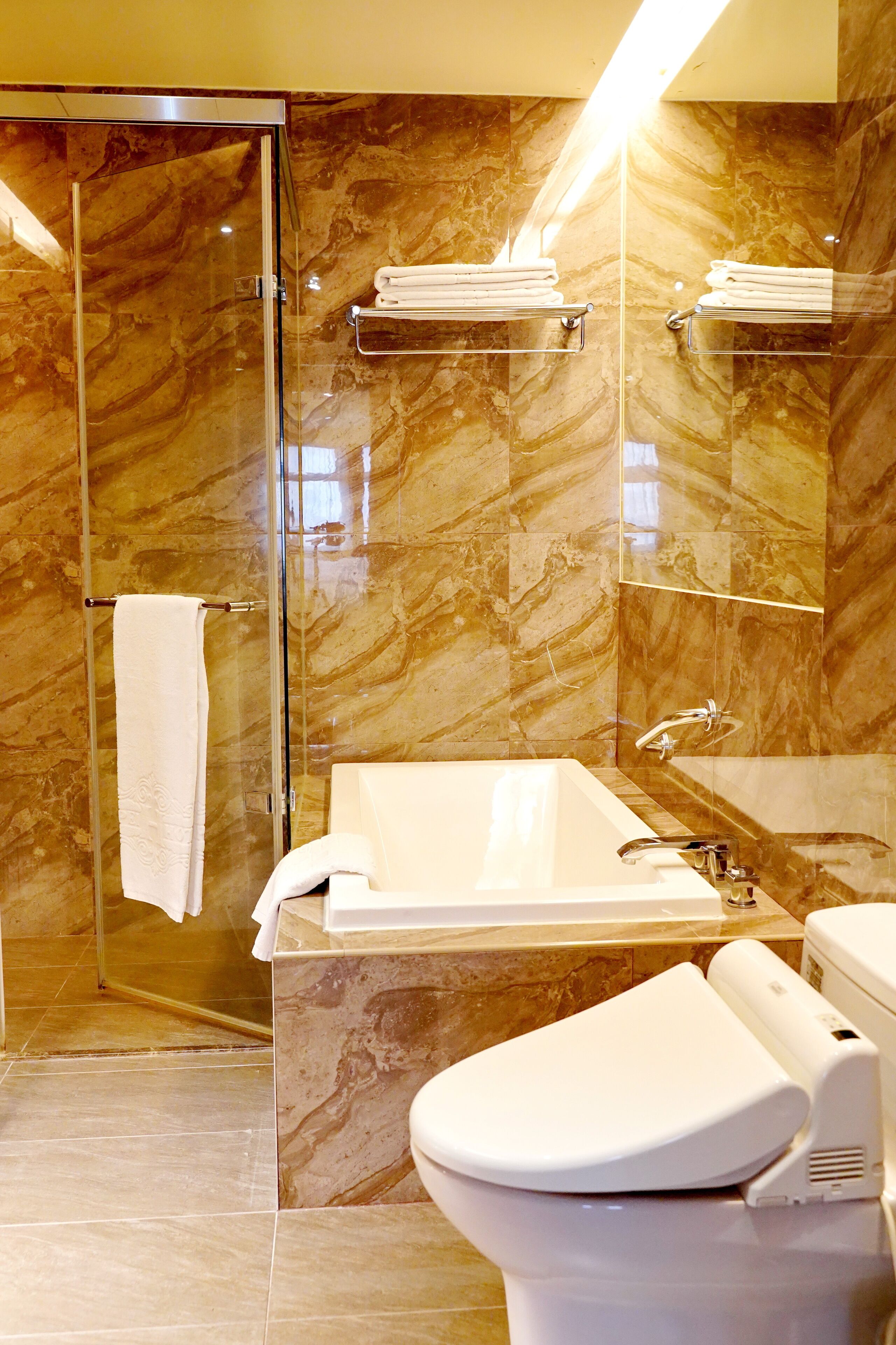 deluxe triple room | bathroom | rainfall showerhead, hair dryer, slippers, electronic bidet