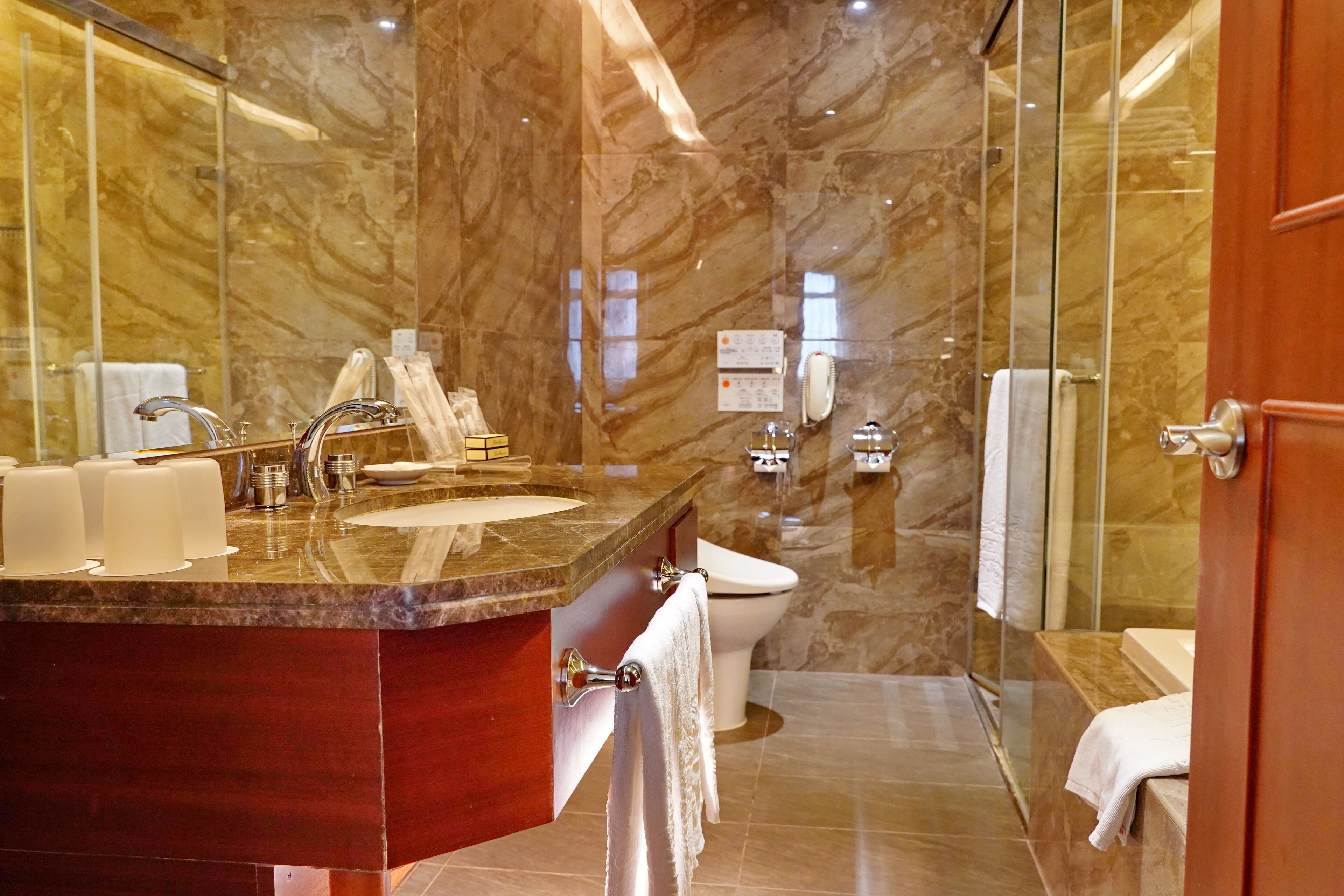 deluxe quadruple room | bathroom | rainfall showerhead, hair dryer, slippers, electronic bidet