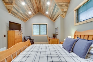 A bedroom with a wooden ceiling, a bed with a plaid bedspread, a desk with a computer, a chair, and a wardrobe. - Pequot Lakes Retreat w/ Beach + Fire Pit! (Pequot Lakes)