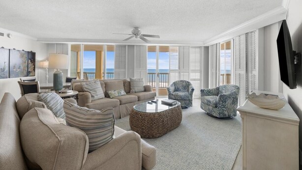 A spacious living room with a sofa set, a coffee table, and a patterned armchair.