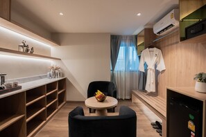 Luxury Honeymoon Suite with Jacuzzi | Living area | 50-inch Smart TV with cable channels, TV, fireplace - Moose Hotel Nimman (Chiang Mai)