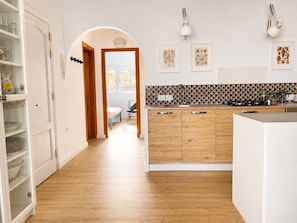 A kitchen with wooden cabinets, a white countertop, and a tiled backsplash. - Large quiet terrace. Only 150 m to the sea. (La Caleta)