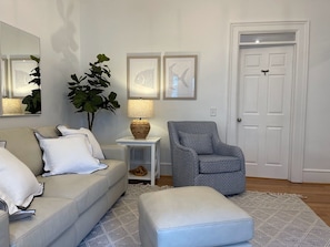 Relax in this stylish living room with a beige sofa, grey armchair, and patterned rug.