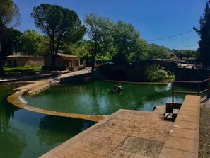 A swimming pool with a bridge, surrounded by trees and a small building. - Provençal loft with a terrace in the heart of the village (salernes)