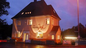A two-story building with a sign reading "Hotel Mama." - Adam Hotel - Giesen (Giesen)
