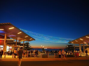 An outdoor area with a covered seating area and a string of lights above. - Absolute Beachfront - simply enjoy  (Henley Beach)