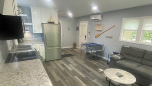 A compact living space with a kitchen, dining area, and seating area. - North Shore Loft, close to everything! (Clear Lake)