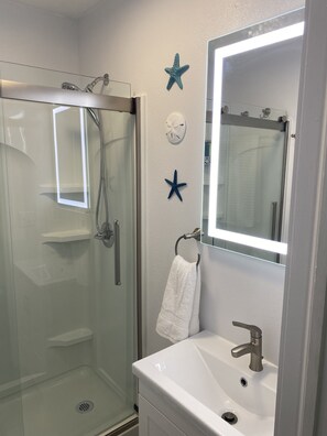 Shower, hair dryer, towels, soap