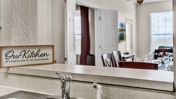 A kitchen counter with a sign that reads 'Our Kitchen If I had to stir it, it's homemade.'