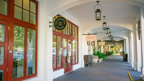 A corridor with a restaurant named "The Daughters Kitchen" and a disco bar. - Gulfside Rosemary "Freedom Carriage House" |Studio |Sleeps 4 | 2 Bikes (Rosemary Beach)