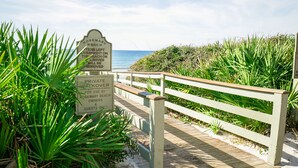 A wooden boardwalk leading to a beach with a sign indicating a private walkway for beach owners and guests. - Gulfside Rosemary "Freedom Carriage House" |Studio |Sleeps 4 | 2 Bikes (Rosemary Beach)