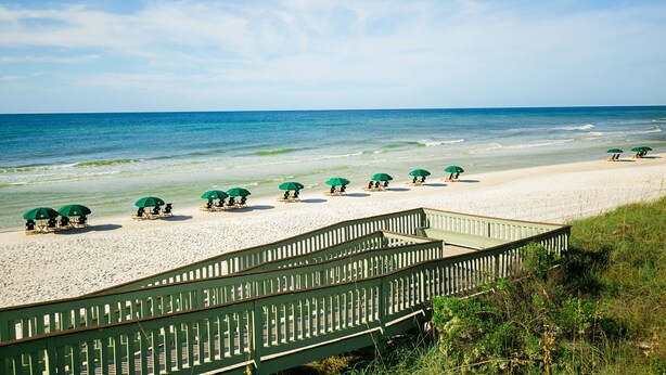 A beach with a wooden walkway leading to beach umbrellas and lounge chairs. - Gulfside Rosemary "Freedom Carriage House" |Studio |Sleeps 4 | 2 Bikes (Rosemary Beach)