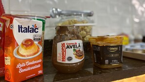 A kitchen counter with various food items including a carton of condensed milk, a jar of chocolate spread, and a container of cream. - Pousada Itaguaçu (Aparecida)