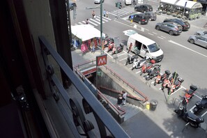 A busy street scene with a crosswalk, parked motorcycles, and a white van.