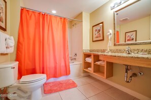 Combined shower/bathtub, towels, soap, toilet paper