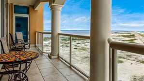 Un balcon avec vue sur la plage et l’océan.